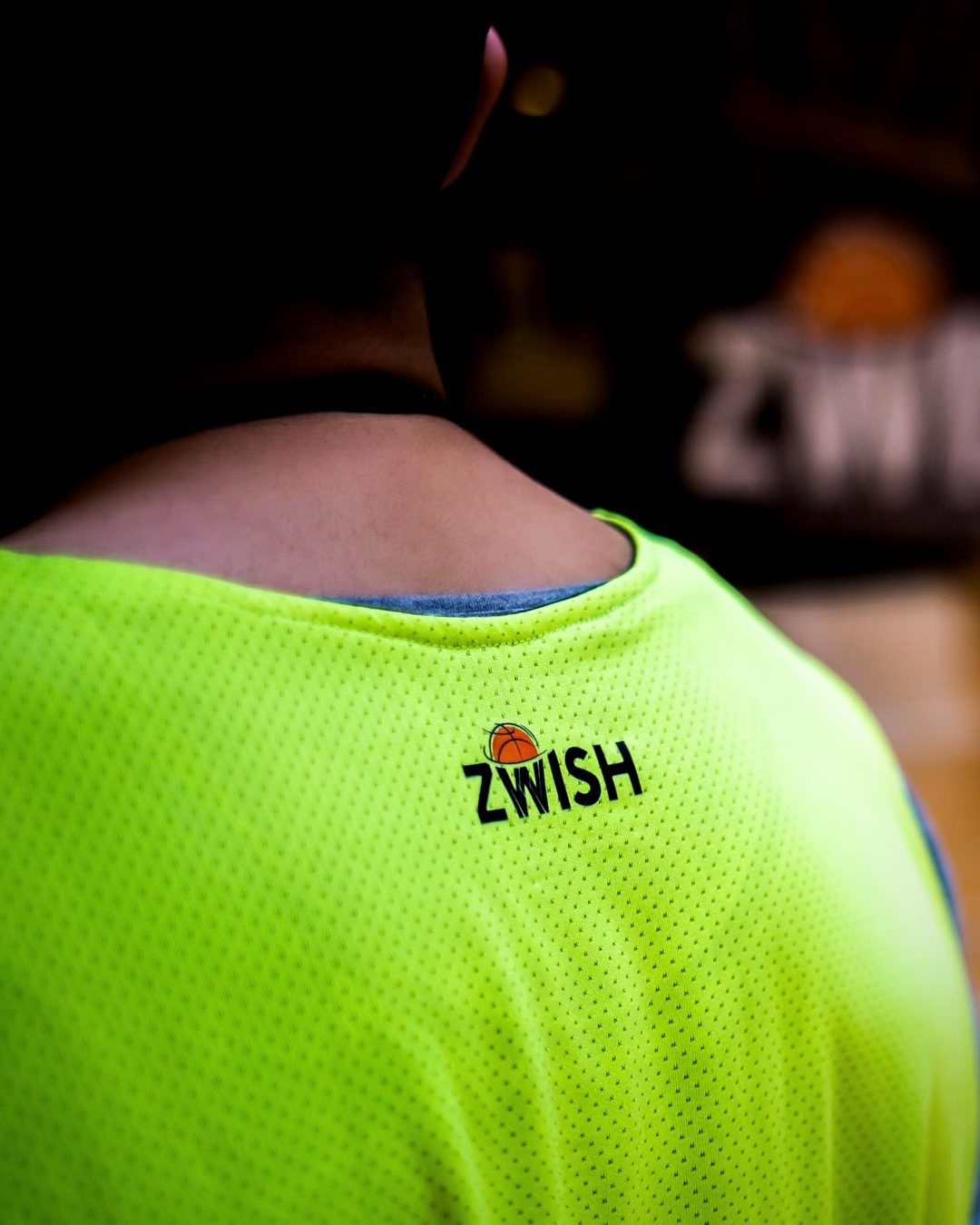 Back of a neon green ZWISH training bib