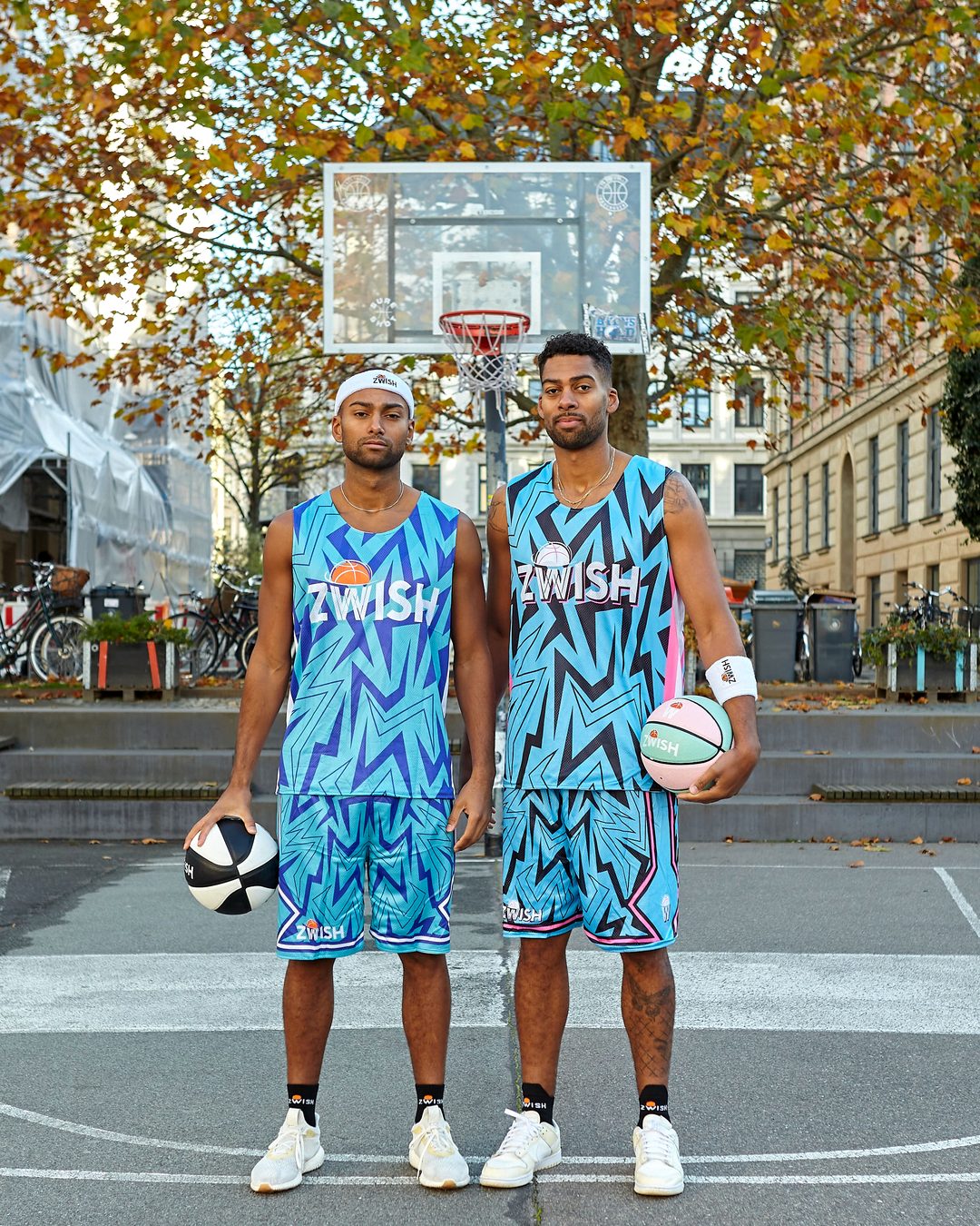 Two ZWISH players in blue zigzag kits on a Copenhagen street court