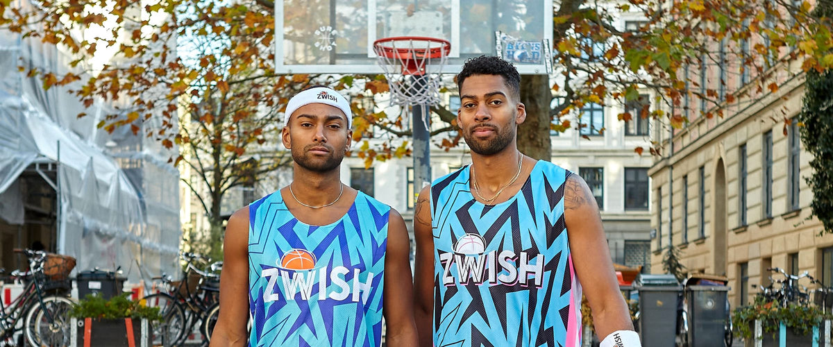 Two ZWISH players in blue zigzag kits on a Copenhagen street court